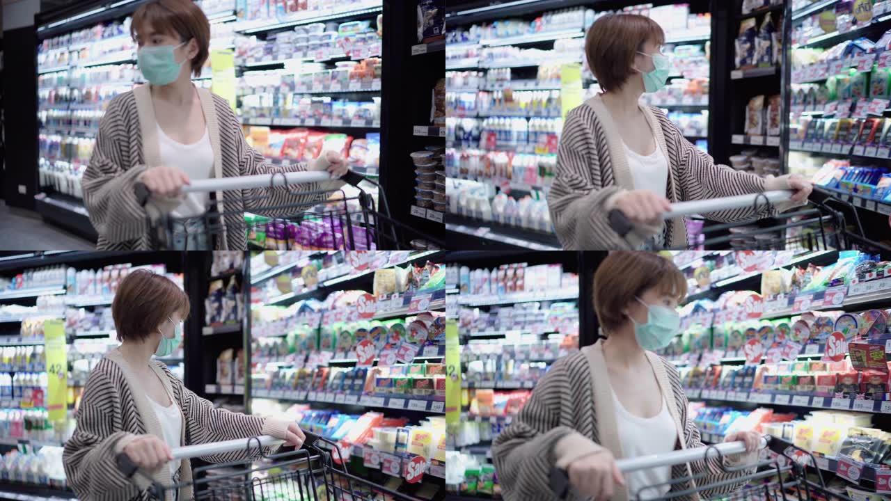 年轻女子在超市购物，带面罩保护