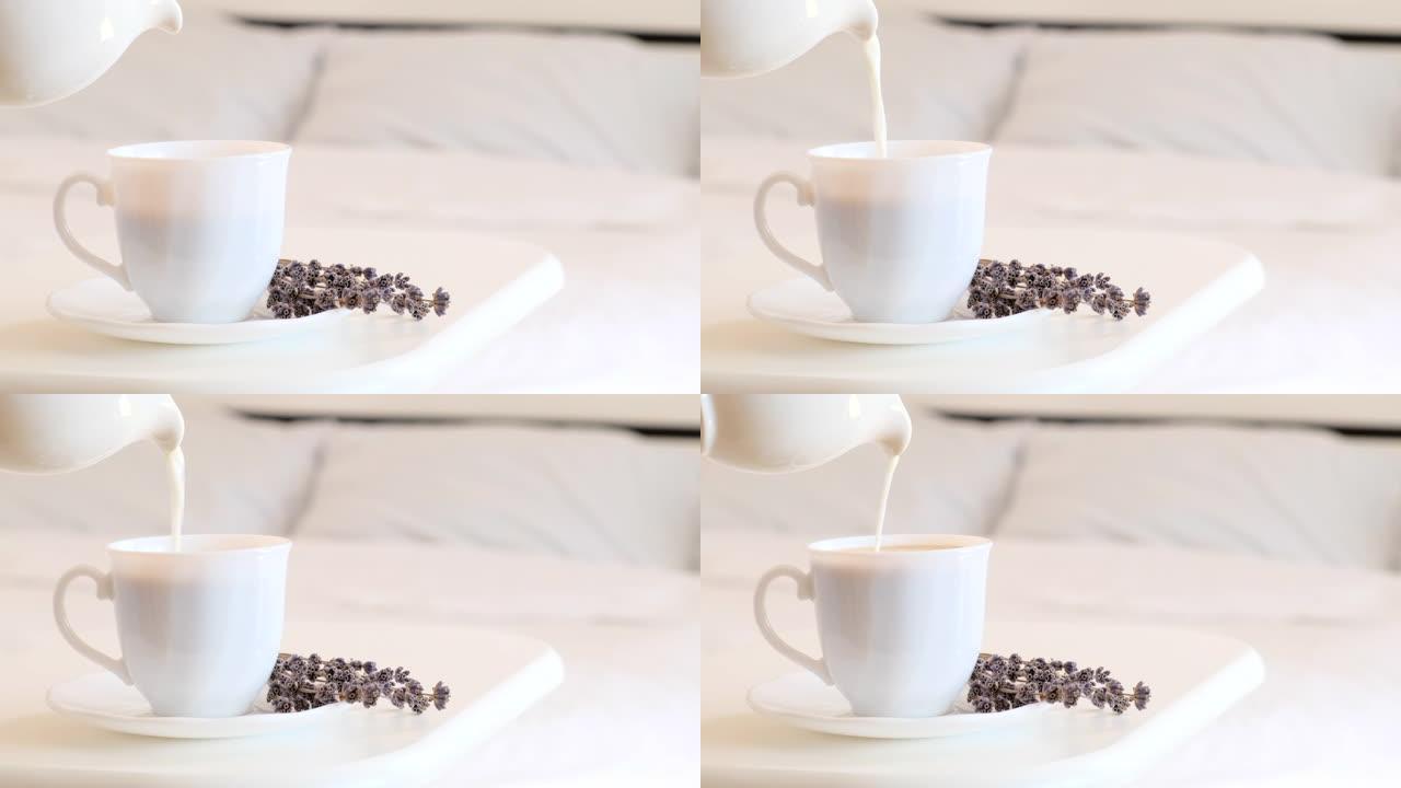 将牛奶倒入热咖啡中。早上早餐概念。床上早餐。在一杯或一杯温暖的卡布奇诺咖啡中添加牛奶