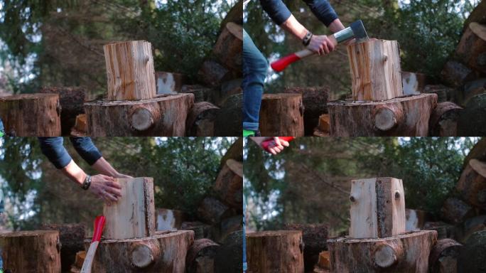 一名男子用重击将斧头刺入木柴。