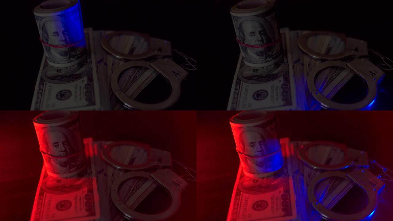 警察闪闪者。手铐在桌子上，很多钱。它们被闪烁的红色和蓝色照亮。