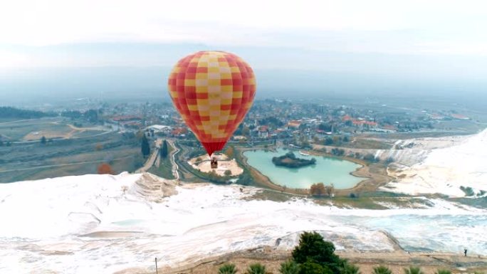 Hot air baloons are flying above pamukkale travert