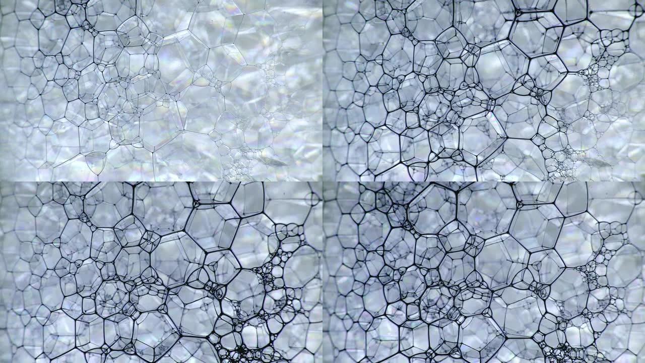 彩色肥皂泡沫与爆裂气泡背景。摘要生物结构，大分子模式。紫色墨水填充了大量在液体中形成的白色小气泡。自