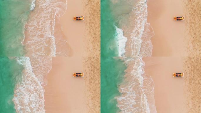 天堂热带岛的海滩度假，性感的晒黑女人在海滩和海上放松。空中俯视图。