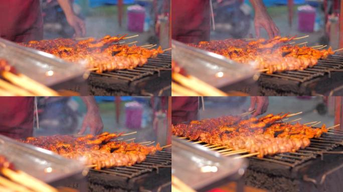 特写镜头烤鸡烧烤与吸烟者快速美味的街头食物选择聚焦浅景深，鸡肉烧烤