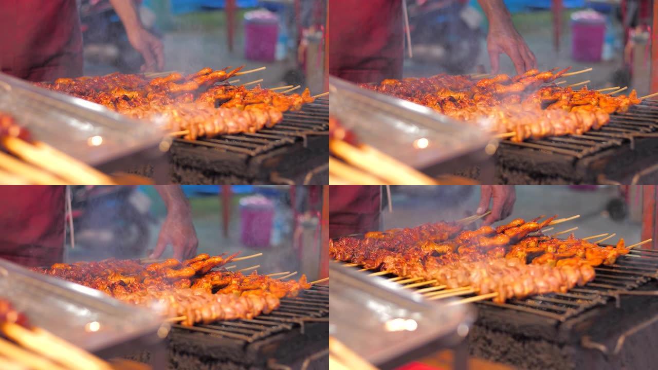 特写镜头烤鸡烧烤与吸烟者快速美味的街头食物选择聚焦浅景深，鸡肉烧烤