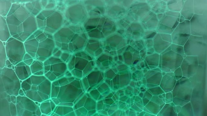 彩色肥皂泡沫与爆裂气泡背景。摘要生物结构，大分子模式。电子x射线墨水填充了在液体中形成的大量气泡。自