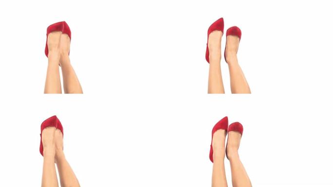 经典风格红色高跟鞋修长腿特写。女性气质和美丽概念。孤立，在白色背景上