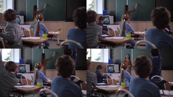 女教师在黑板上写数学方程