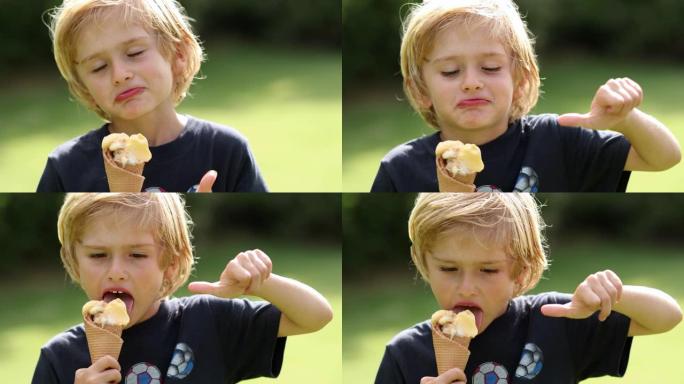 金发小男孩吃冰激丸，竖起大拇指