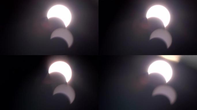 太阳日食概念，白天2019年12月日食上的运动强光，就像望远镜相机上的眼镜看太阳一样