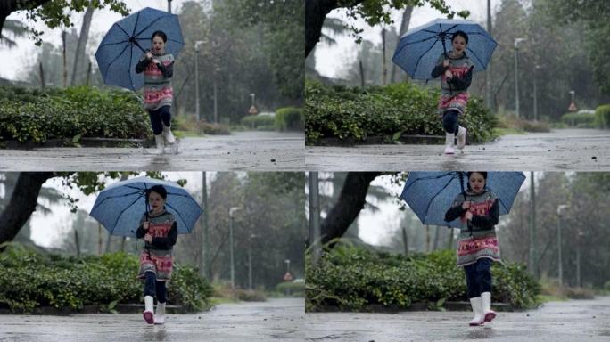 一个小女孩在水坑里跳伞的慢动作在雨中撑着伞