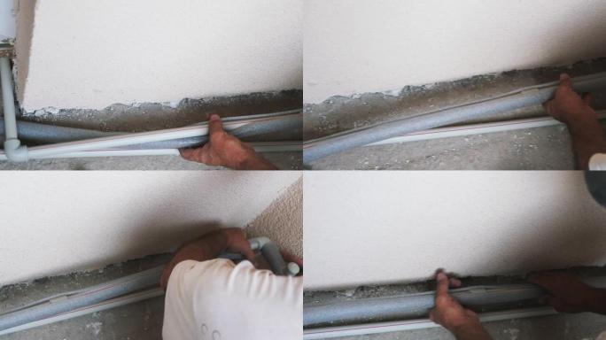 工人用聚氯乙烯涂层覆盖卫生管道。管道连接处由建筑工人用涂层覆盖。