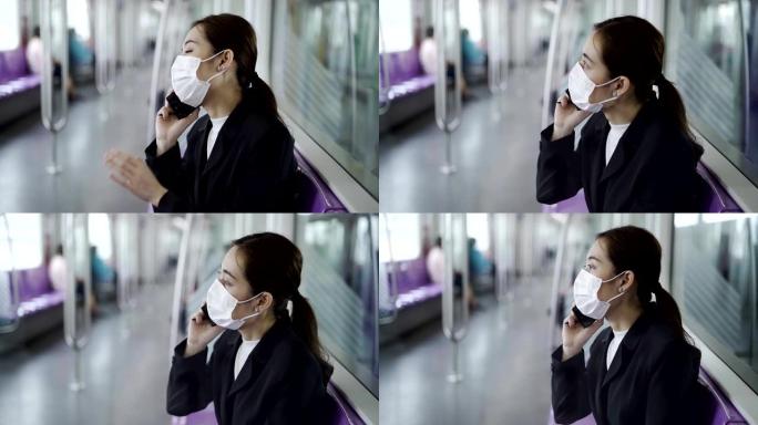 在新型冠状病毒新型冠状病毒肺炎肺炎爆发期间，一名戴着黑色外科口罩的年轻亚洲妇女在地铁列车上的特写