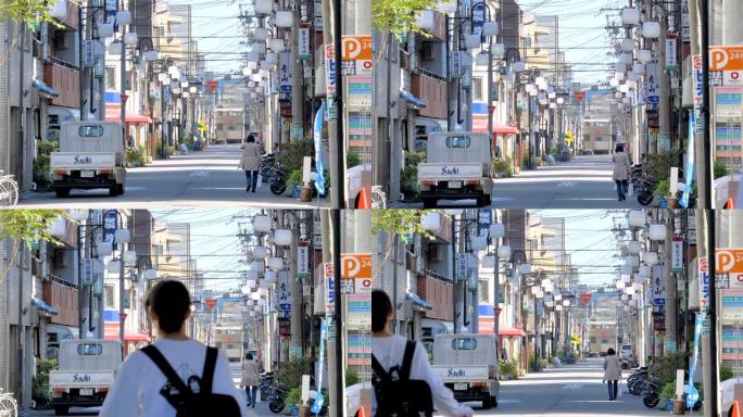 一位女士走在日本大阪的路边