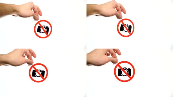 在白色上显示警告标志 “no camera” 的手