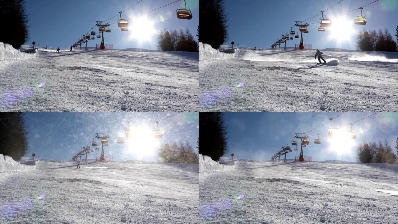 滑雪者在灿烂的阳光下在滑雪场上滑雪