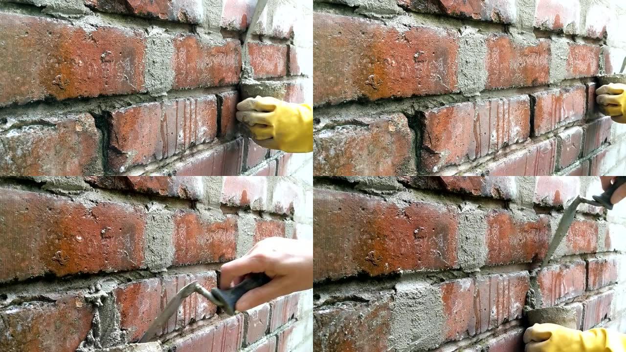 女人用砂浆指着砖墙的时间流逝。