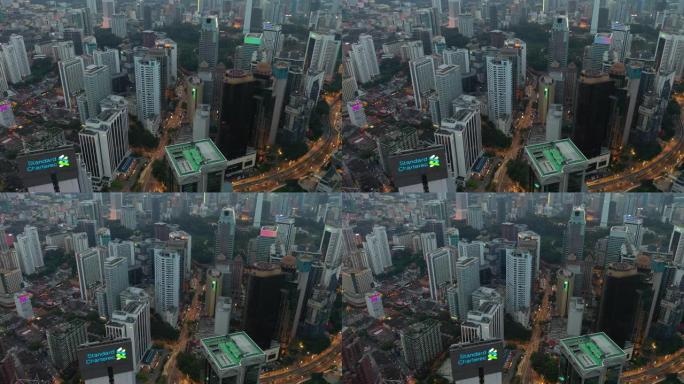 暮光之城照明吉隆坡市区在交通街上飞行空中全景4k马来西亚