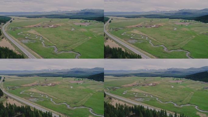 初春，蒙大拿州邦纳普莱西德湖州立公园附近的山脉之间的山谷的空中风景。用全景摄像机运动驱动视频镜头。