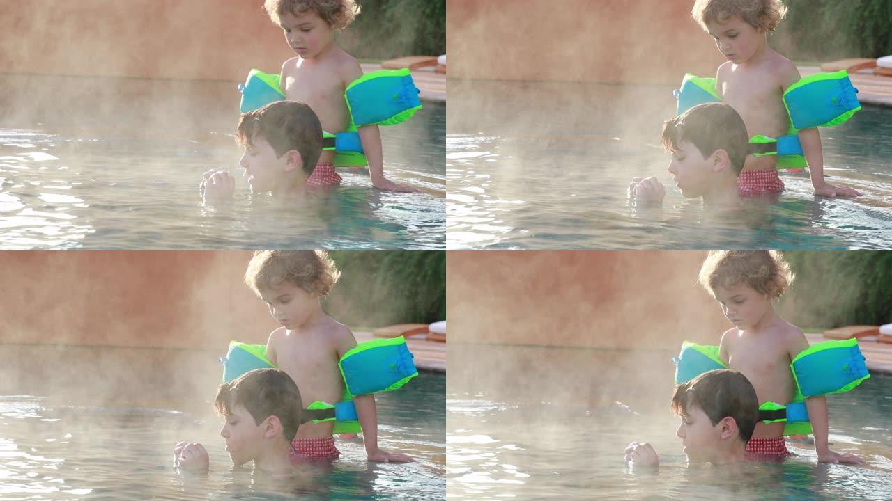 儿童在温暖的游泳池水中