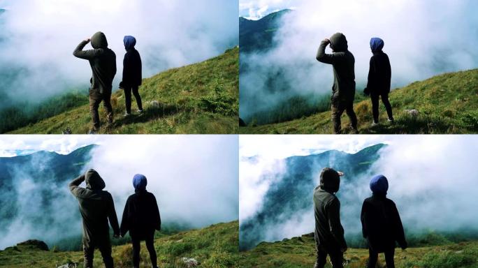 男人和女人站在山上看着