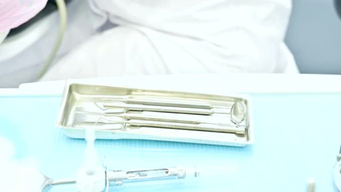 一个靠近一个金属注射器的staminology仪器。牙科设备。口腔卫生保健理念