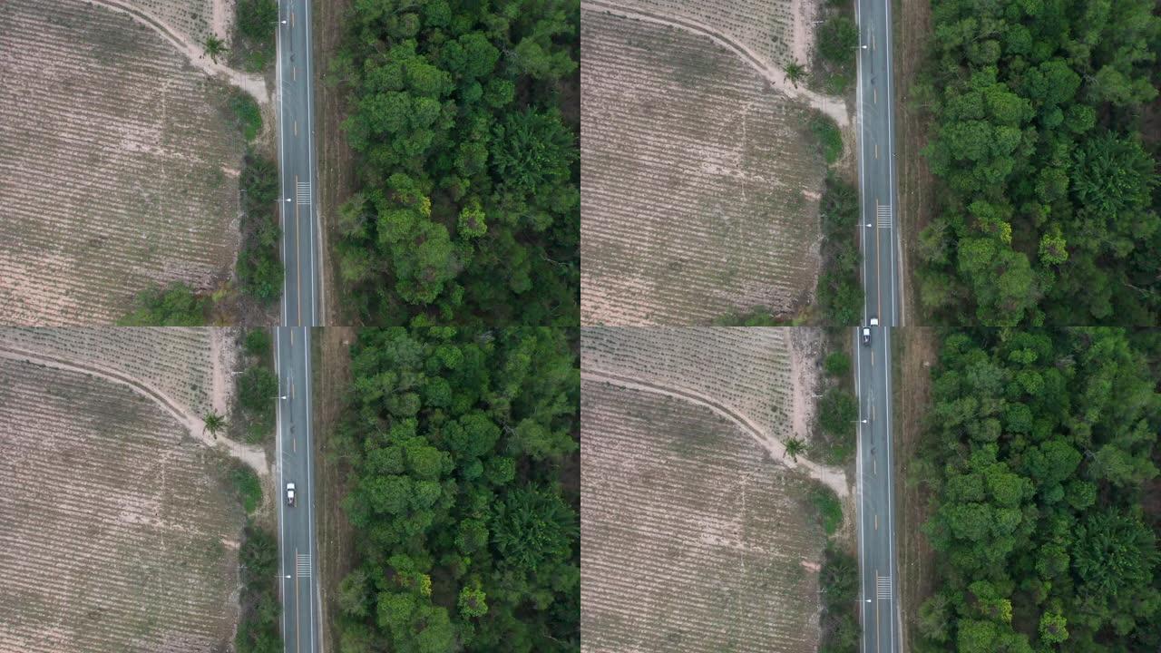 鸟瞰图比较农场道路绿地与道路上的汽车