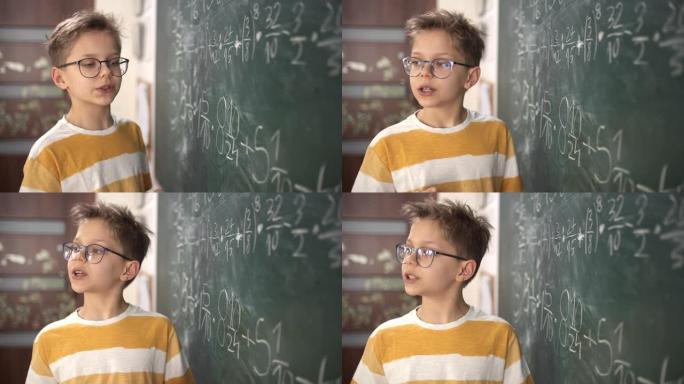 可爱的小男孩在数学课上解释分数计算