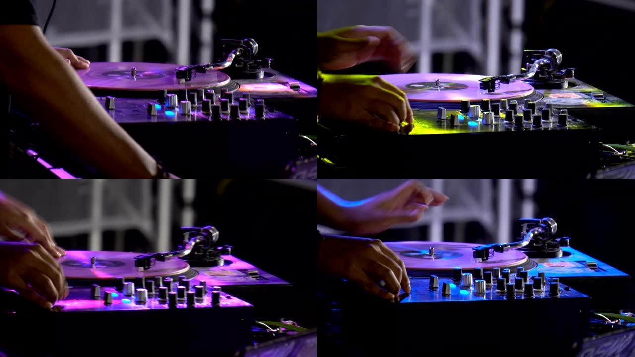 户外迪斯科派对上触摸按钮和滑块播放电子音乐Dj调音台的手的特写