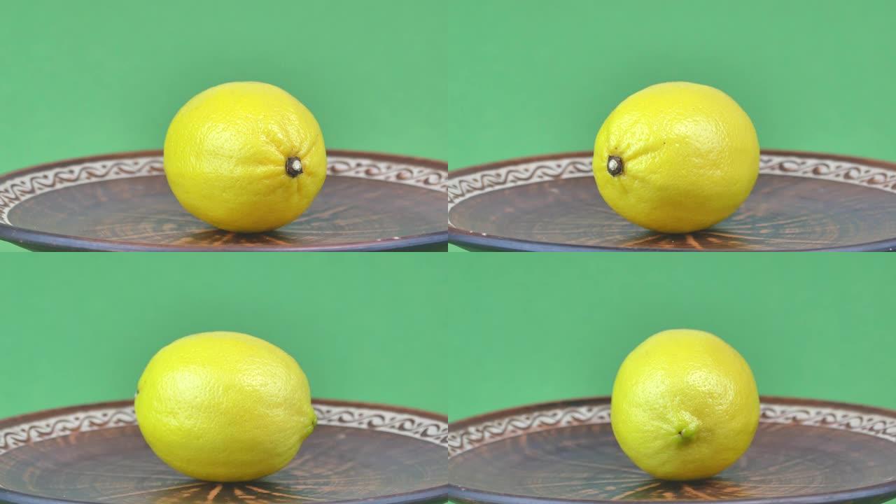 绿色背景上的黄色柠檬水果。食品。视频。