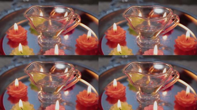 按摩师purs按摩oil in a glass container。Candles are burn