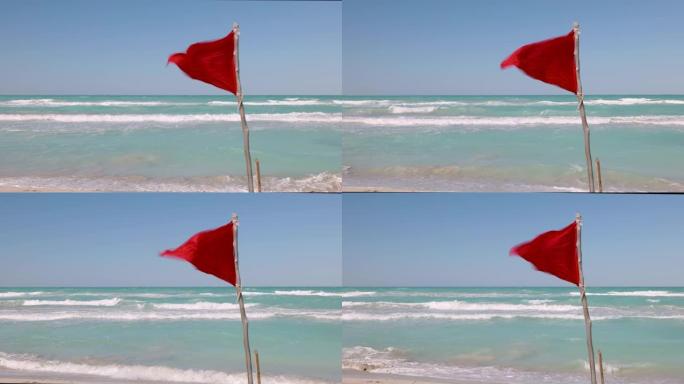 红色警告旗在海滩上狂风飘扬，以提醒人们不要游泳