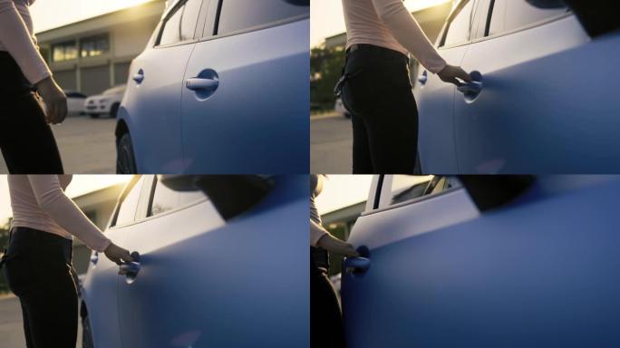 潘拍，女人的手系统钥匙在驾驶慢动作前解锁车门，蓝色两厢车的车辆运输在街道上行驶。电影镜头