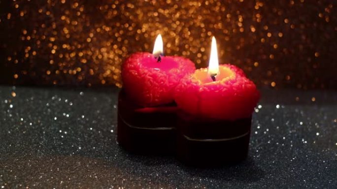 情人节，在闪亮的背景上燃烧着蜡烛的框架