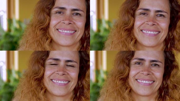一位迷人的拉丁裔女性微笑着看着镜头的特写镜头