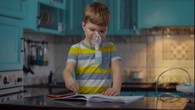小男孩使用吸入器治疗流感或呼吸道病毒等疾病，并在家里用彩色铅笔绘画。厨房用药物吸入器治疗咳嗽的孩子 
