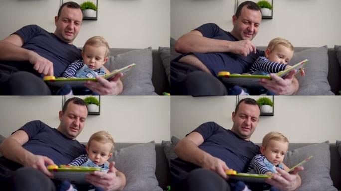 快乐的孩子和他的爸爸一起在家看书