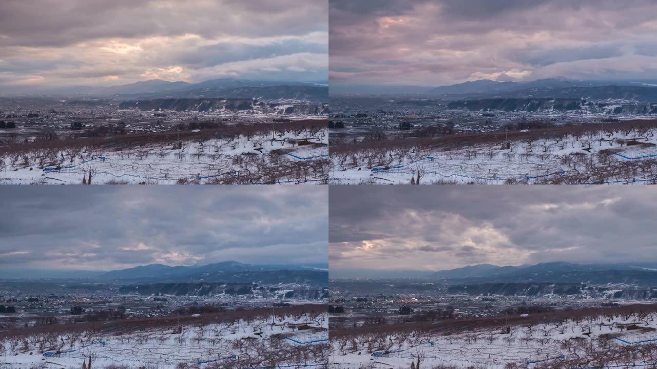 日本长野，冬季中野市的延时鸟瞰图，苹果树在日落时的前景