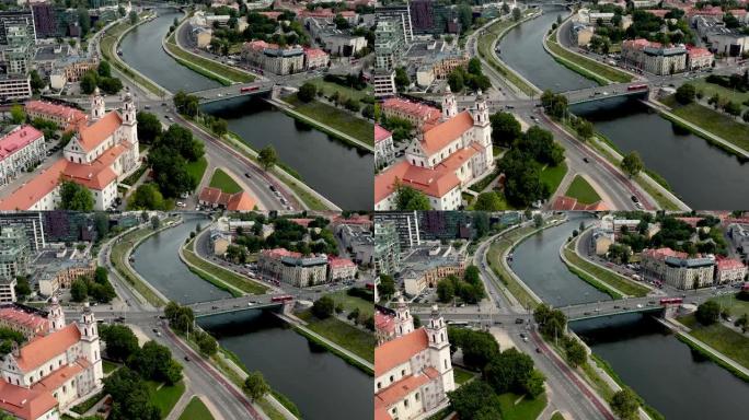 立陶宛维尔纽斯-2019年7月: 天使长拉斐尔教堂和内瑞斯河上的桥梁的空中无人机视图。