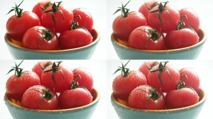 水滴新鲜的红色樱桃番茄。喷在西红柿上