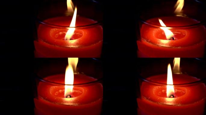 蜡烛火焰在黑暗背景上隔离的特写镜头