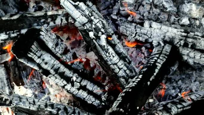 火中燃烧的柴火，煤和灰烬的特写