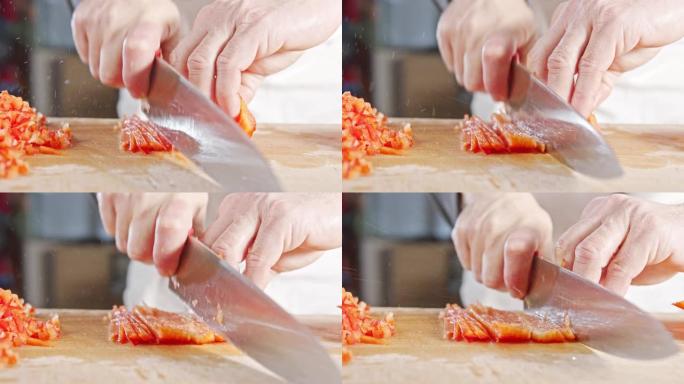 厨师刀切成红色甜椒的慢动作特写