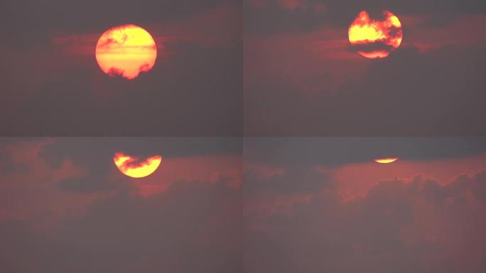 美丽的巨大红色日出，前景有云。