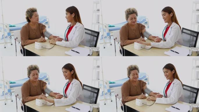 医生在医院的办公室里使用血压计检查老年妇女患者