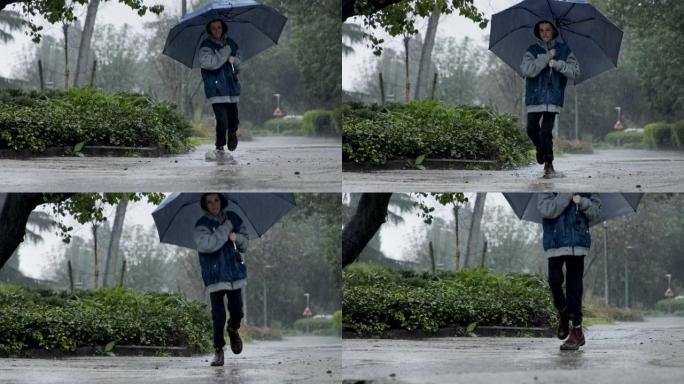 一个小男孩在倾盆大雨中跳伞的慢动作