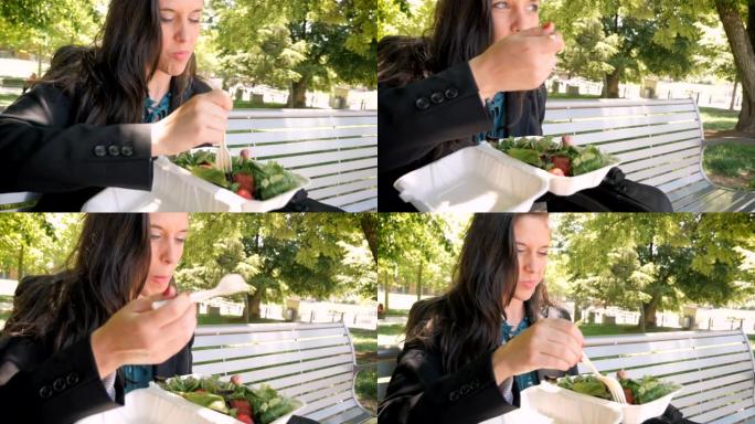年轻女子吃营养健康的草莓混合绿色沙拉