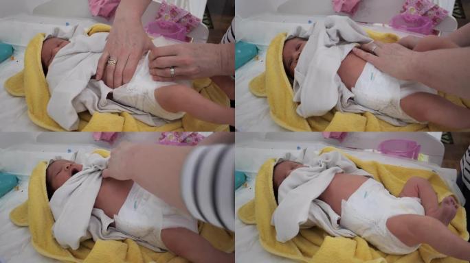 换尿布的新生女婴照顾照料新生儿小宝宝