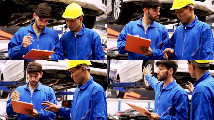 男子专家汽车维修中的汽车修理工检查机器诊断。和他的团队。