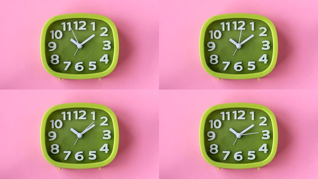 粉红色背景上有白色数字和箭头的绿色时钟